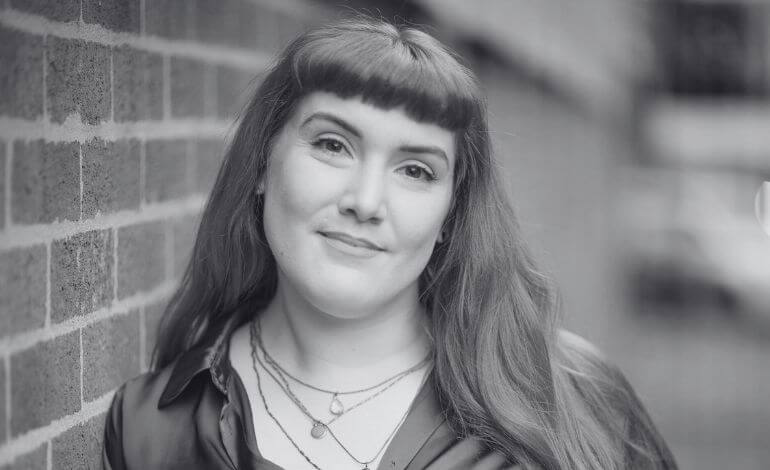 Lexy Webster, Freelance Digital Marketer from Sheffield with long hair wearing a stylish silk shirt, exuding confidence and a modern vibe.